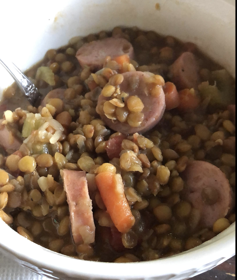 bowl of lentils carrots and sausage soup